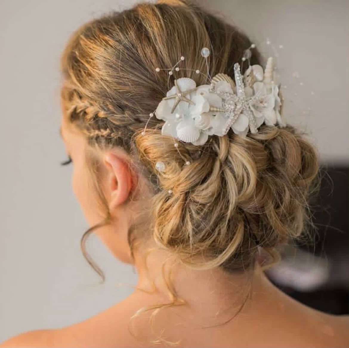 Bridal hair by Lee Elrom — braided updo with a pearl and seashell comb