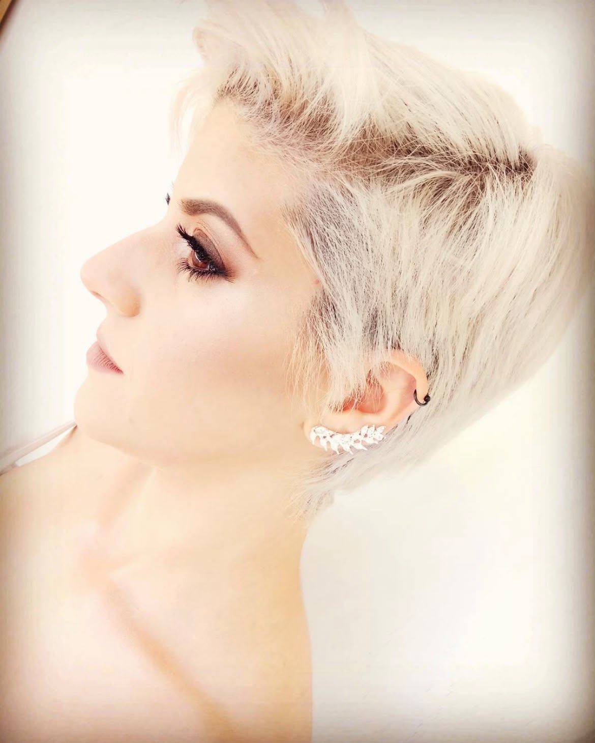 Bridal makeup by Lee Elrom — platinum pixie cut with bronze smoky eyes and a crystal ear cuff
